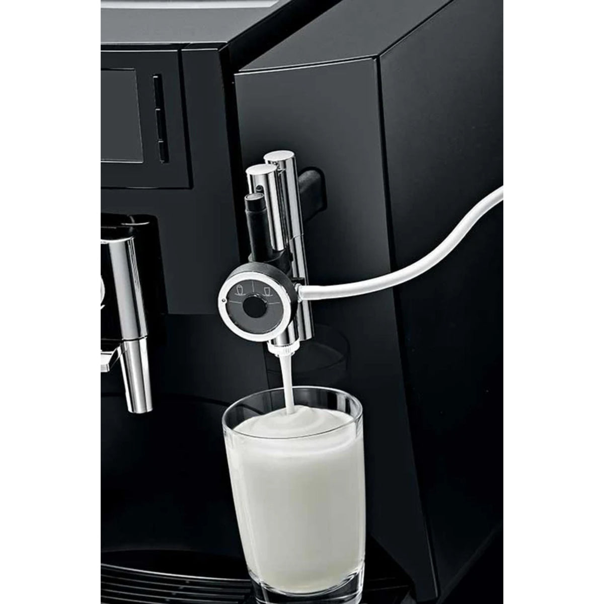 JURA Professional fine‑foam nozzle EA (24251) connected to a black coffee machine, with white tubing and a stream of milk foam into a