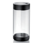 Siemens Glass milk container 0.7 l (TZ80008) – transparent cylindrical glass jar with black lid and black base.
