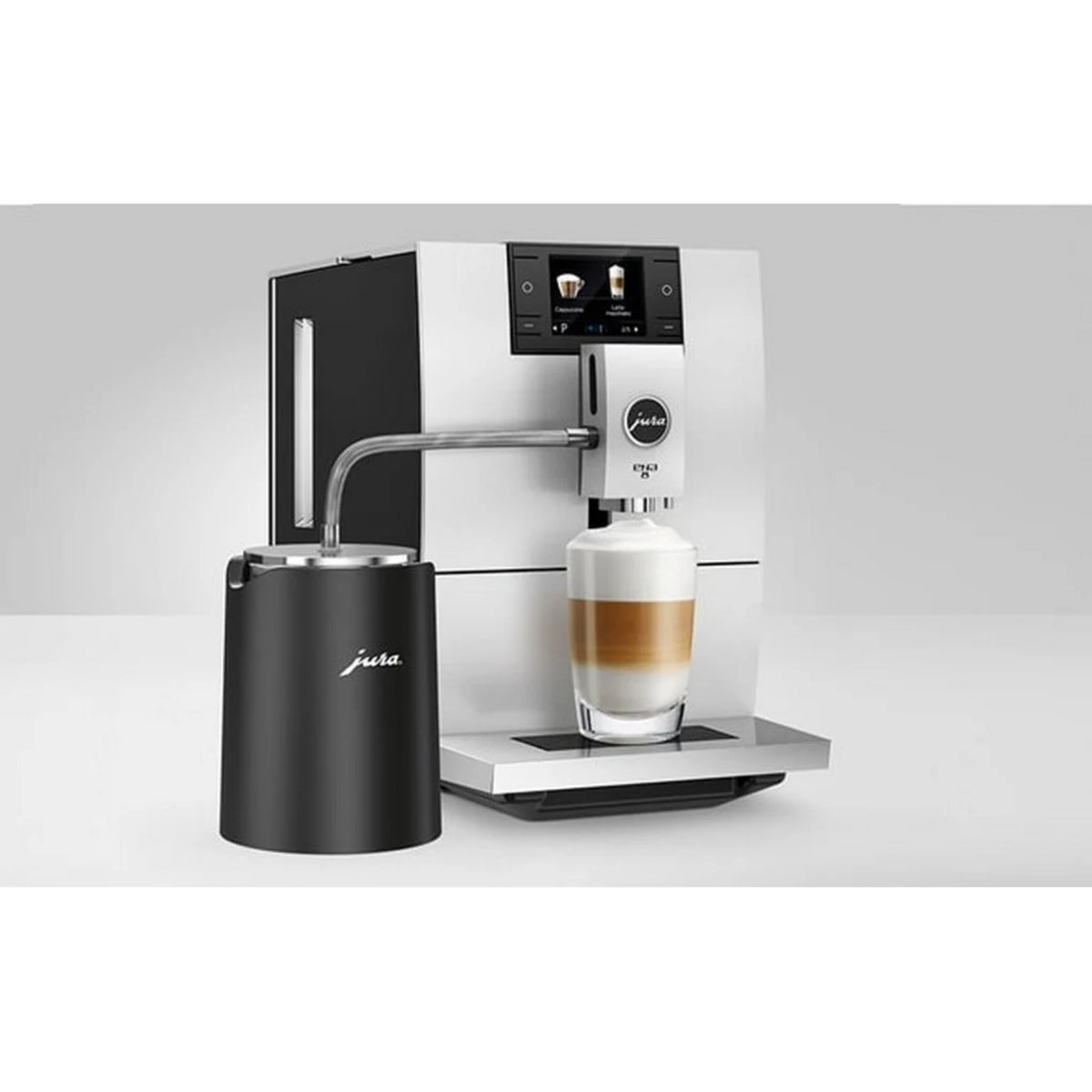 JURA Glacette cooler for glass milk container black (24167) next to a coffee machine, black cylindrical cooler with tube connected to